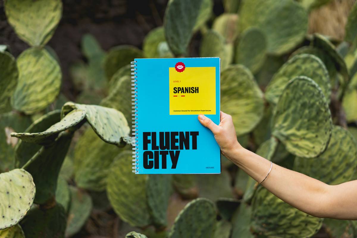 el espanol travel inc phrasebook open on a train seat with passport and coffee